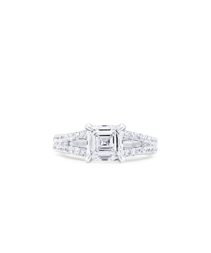 Diamond engagement ring with a central asscher cut diamond and a split shank diamond pave band with smaller diamonds