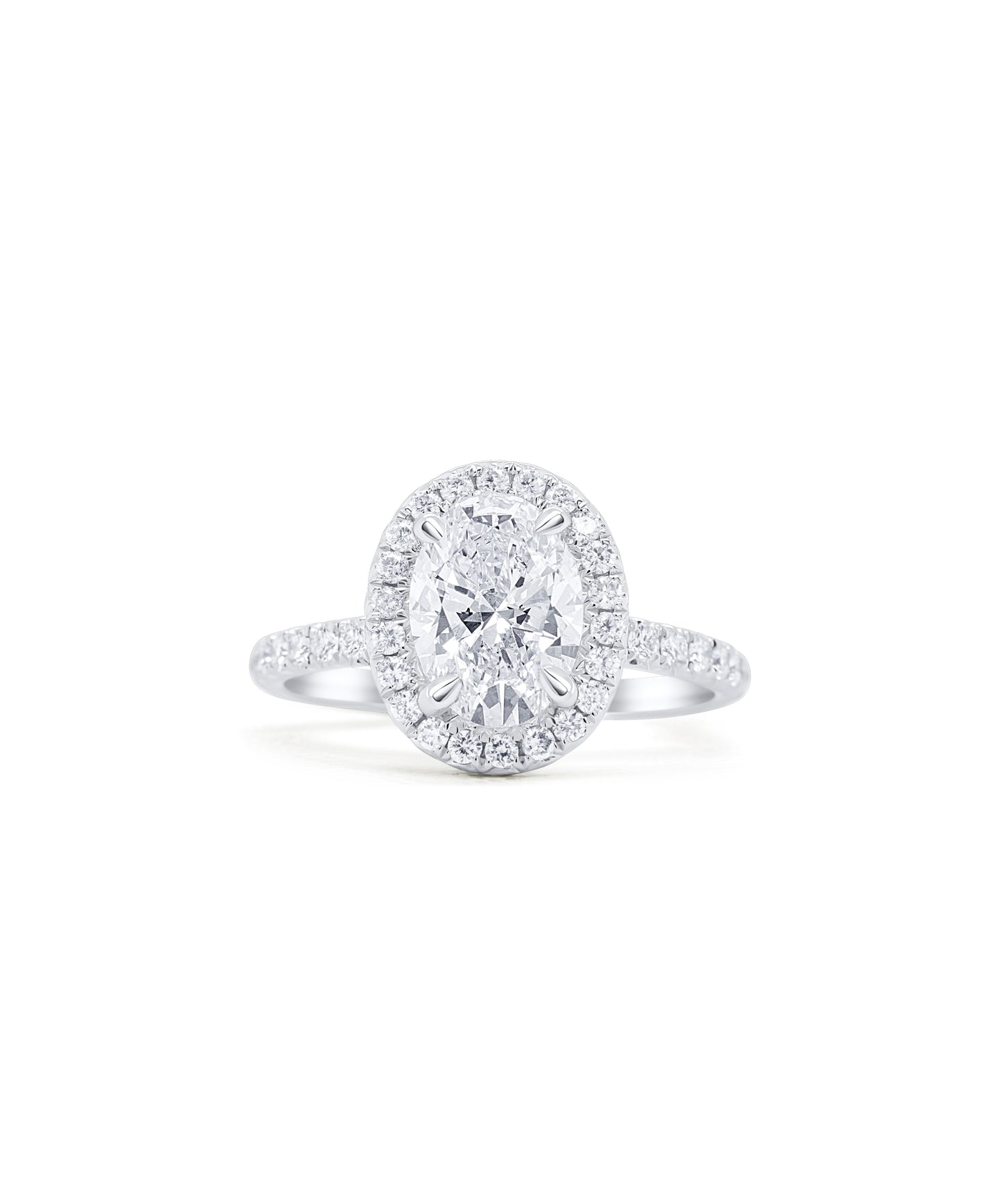 Oval Cut diamond engagement ring set in claw prongs with a diamond halo and band with diamonds pave set halfway around 