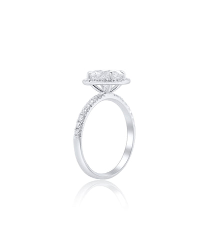 Oval Cut diamond engagement ring set in claw prongs with a diamond halo and band with diamonds pave set halfway around 